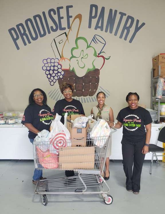 Volunteers posing with donation cart