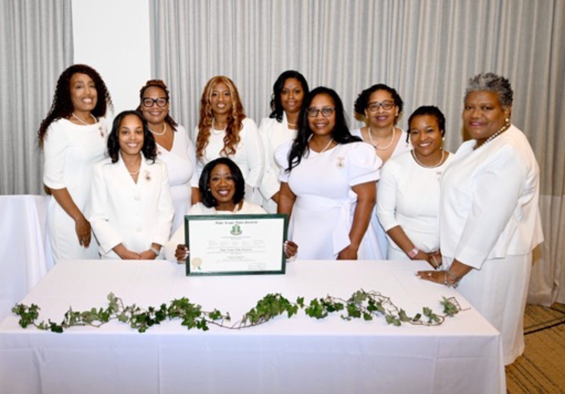 Women posing with a certificate