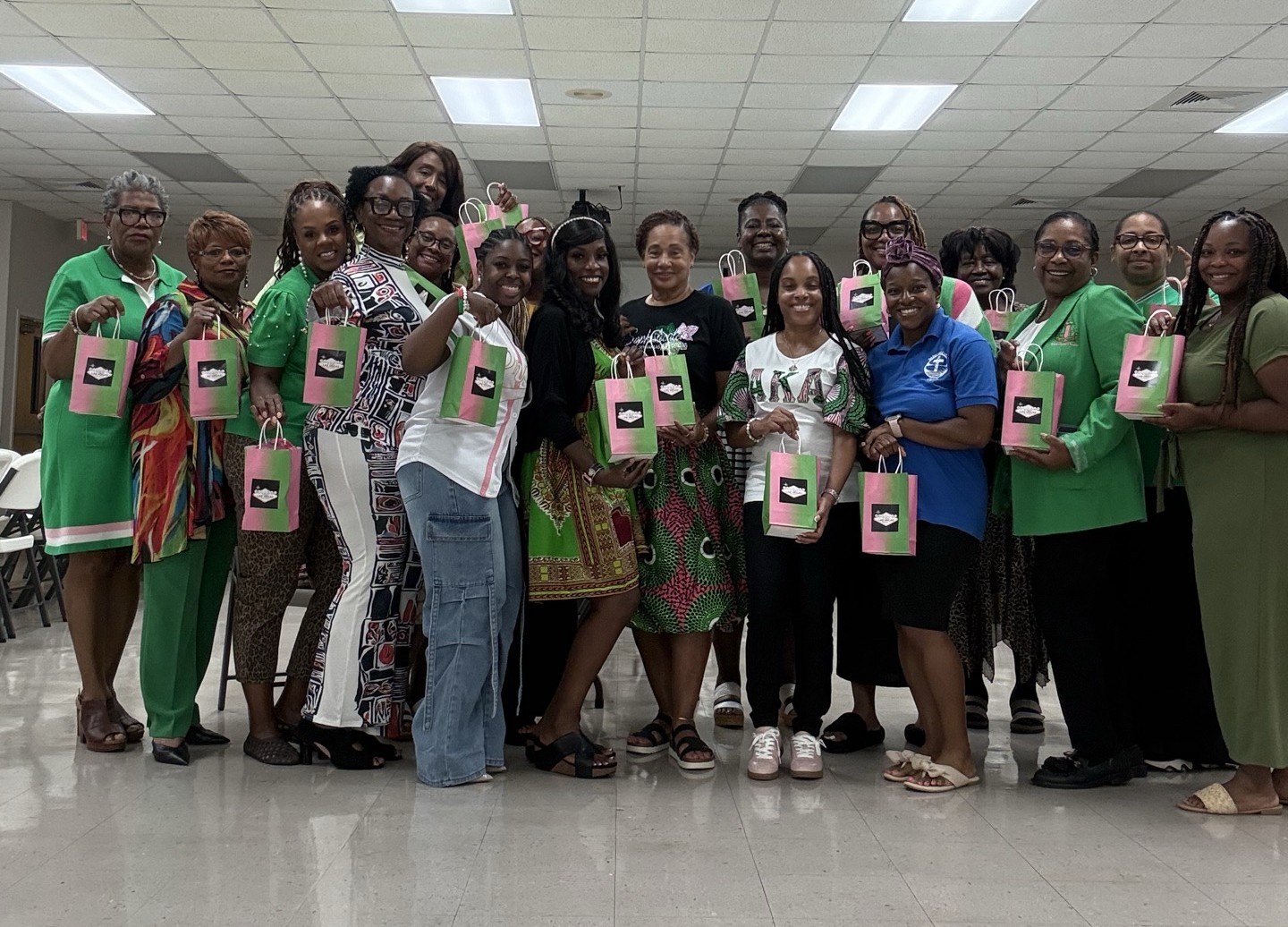 Group holding gift bags, smiling indoors.