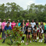 Community members gathered outdoors for tree planting