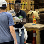 Smiling woman giving package