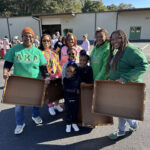 Community gathering with trays in sunlight