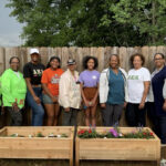 Group posing by garden planters